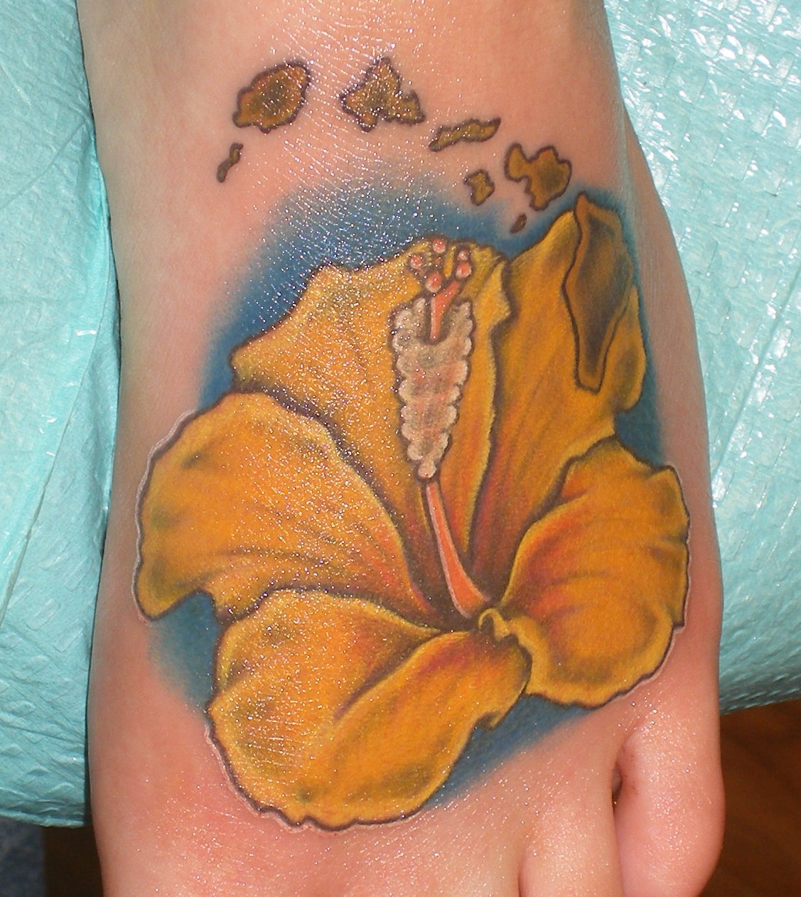 Colored Yellow Hibiscus Tattoo On Foot