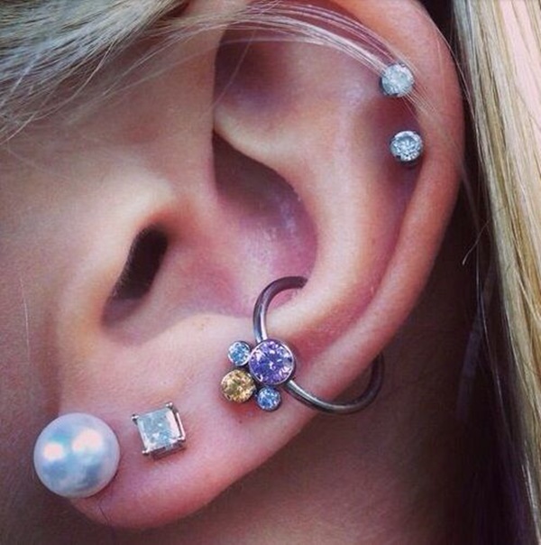 Dual Lobes And Outer Conch Piercing On Girl Left Ear
