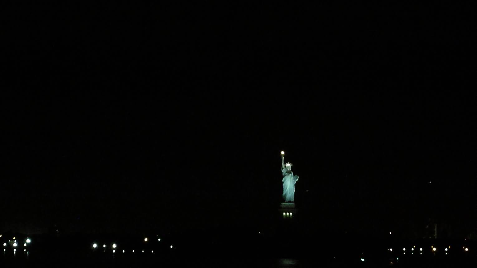 Far View Of Statue Of Liberty At Night