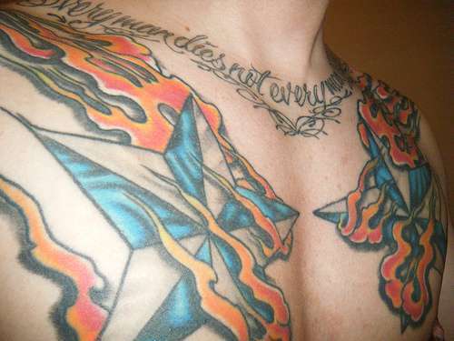 Flaming Nautical Stars Tattoo On Chest