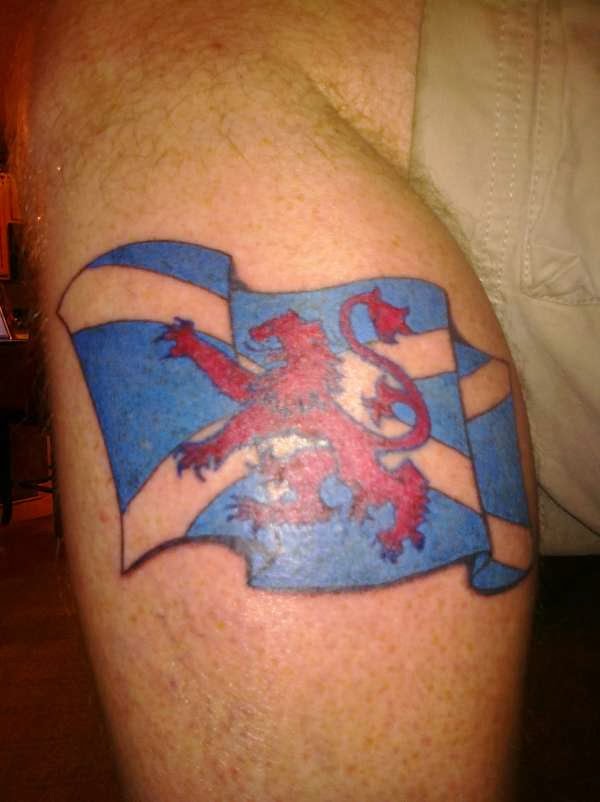 Flying Scottish Flag Tattoo On Leg