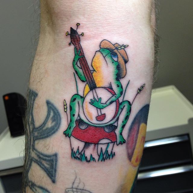 Frog Playing Banjo Traditional Tattoo On Arm