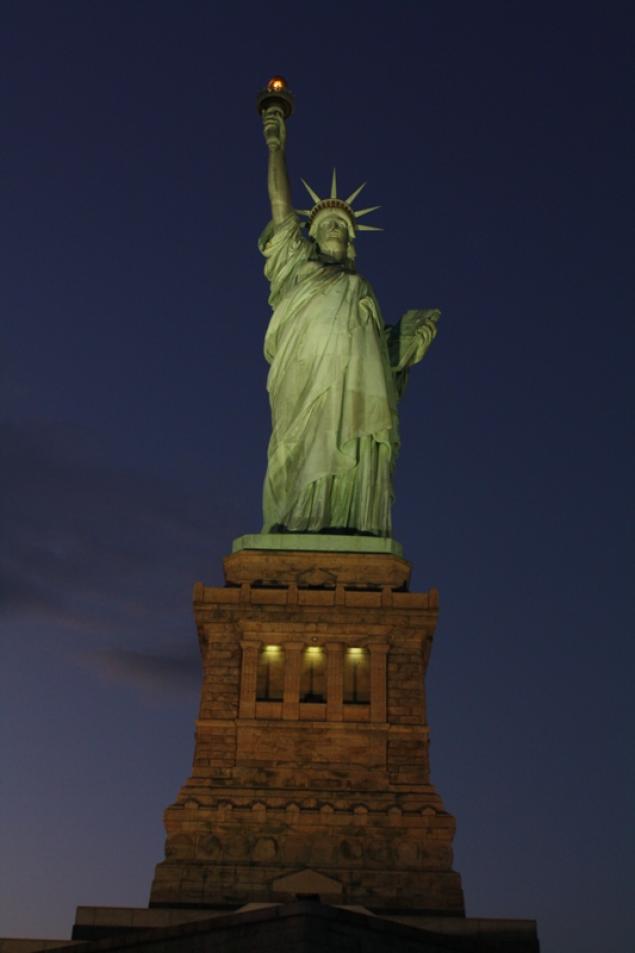 Front View Of Statue Of Liberty And Base At Night