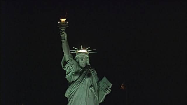 Front View Of Statue Of Liberty Illuminated At Night New York City