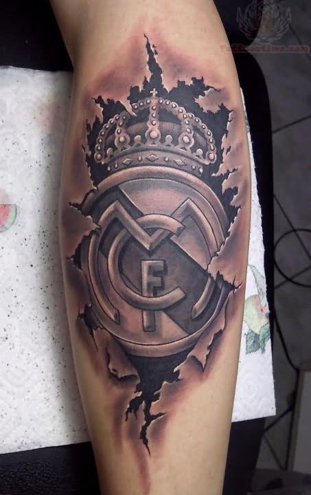 Grey Ink Ripped Skin Real Madrid Logo Tattoo On Leg