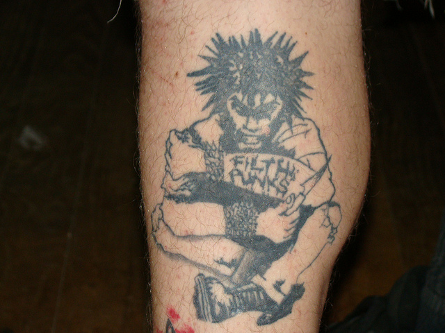 Mad Grey Ink Punk Tattoo On Leg