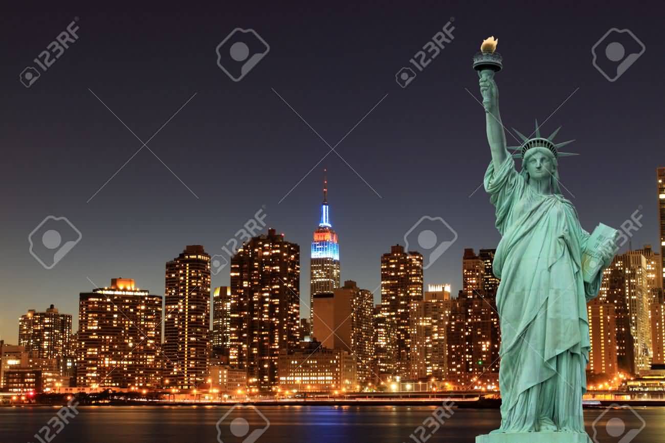 Manhattan Skyline And Statue Of Liberty At Night