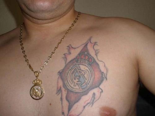 Nice Ripped Skin Real Madrid Logo Tattoo On Chest