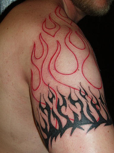 Red And Black Tribal Flame Tattoo On Shoulder