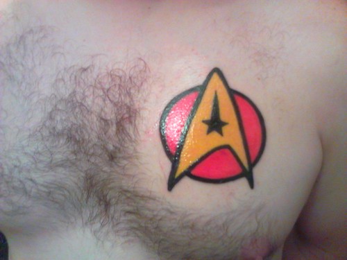 Red And Yellow Star Trek Insignia Tattoo On Chest For Men