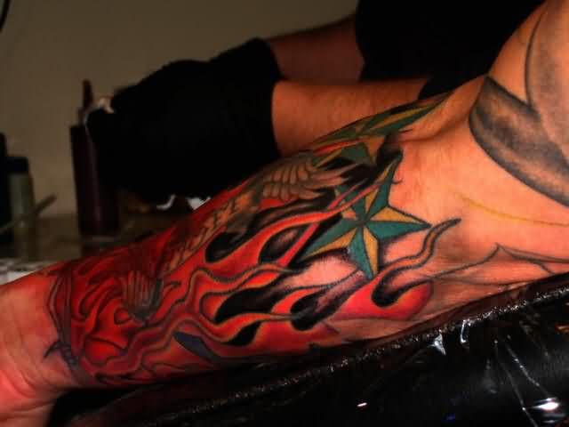 Red Flame Tattoo On Forearm