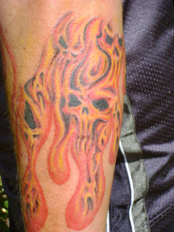 Red Ink Evil Flame Tattoo On Arm