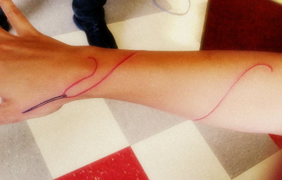 Red Long Thread Sewing Needle Tattoo On Arm Sleeve