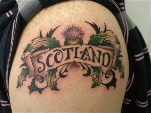 Scottish Thistle With Banner Tattoo On Shoulder