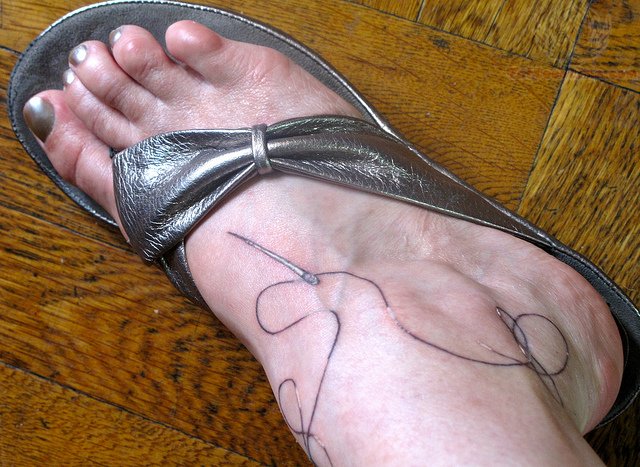 Sewing Needle Tattoo On Right Foot