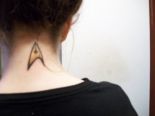 Simple Yellow Star Trek Tattoo For Girls