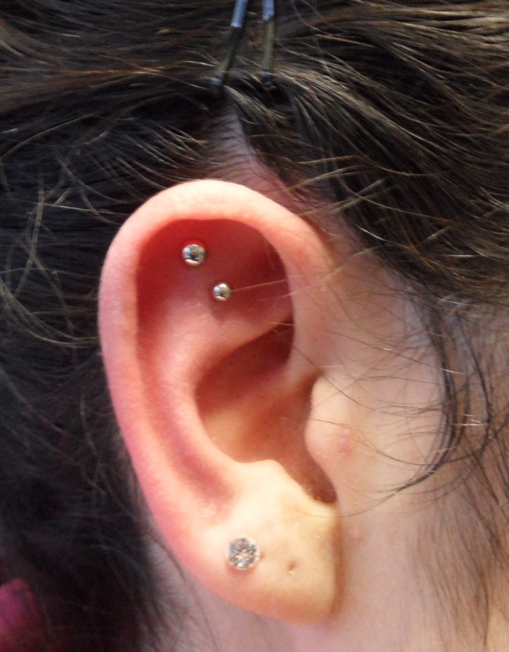 Single Lobe And Outer Conch Piercing For Young Girls