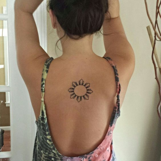Small Filipino Sun Tattoo On Girl Upper Back