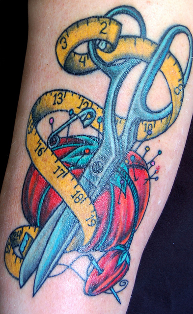 Spool And Needles Sewing Tattoo On Arm
