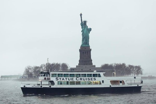 Statue Cruises Passing From Statue Of Liberty