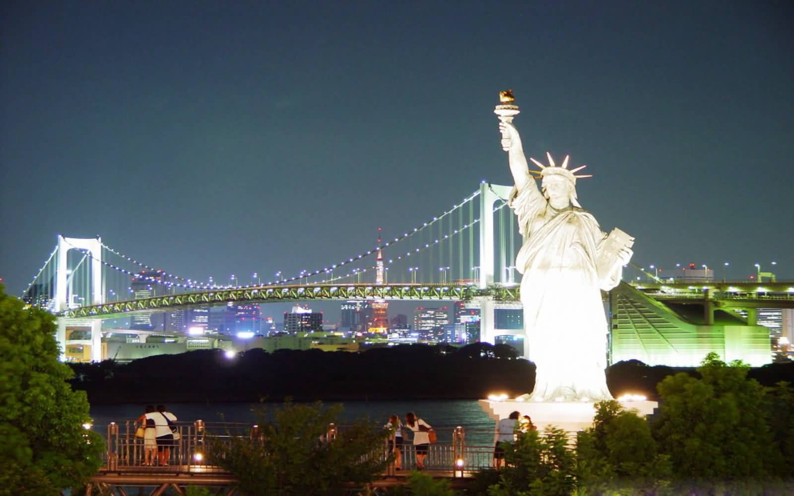 Statue Of Liberty And Brooklyn Bridge At Night