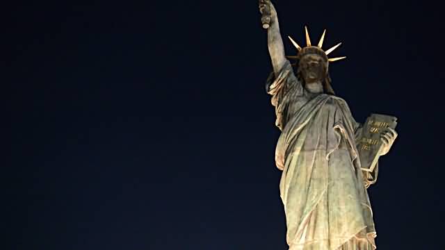 Statue Of Liberty Illuminated At Night In New York City