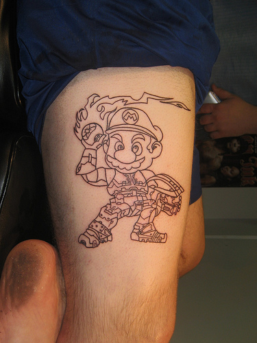 Super Mario With Fire Tattoo On Thigh
