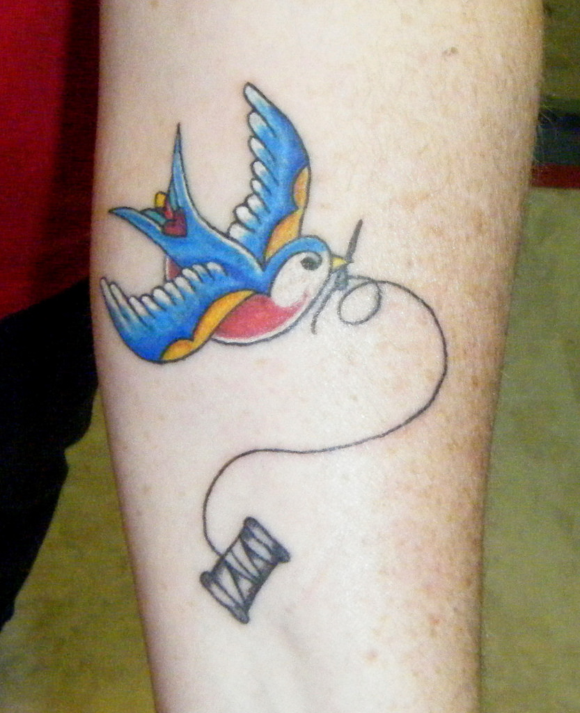 Swallow And Spool Sewing Tattoo On Forearm
