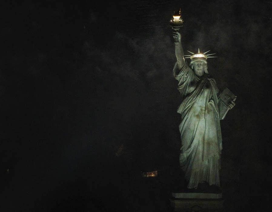 The Statue Of Liberty On Liberty Island In New York City At Night