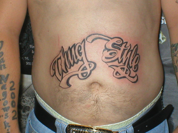 Thug Style Lettering Tattoo On Stomach