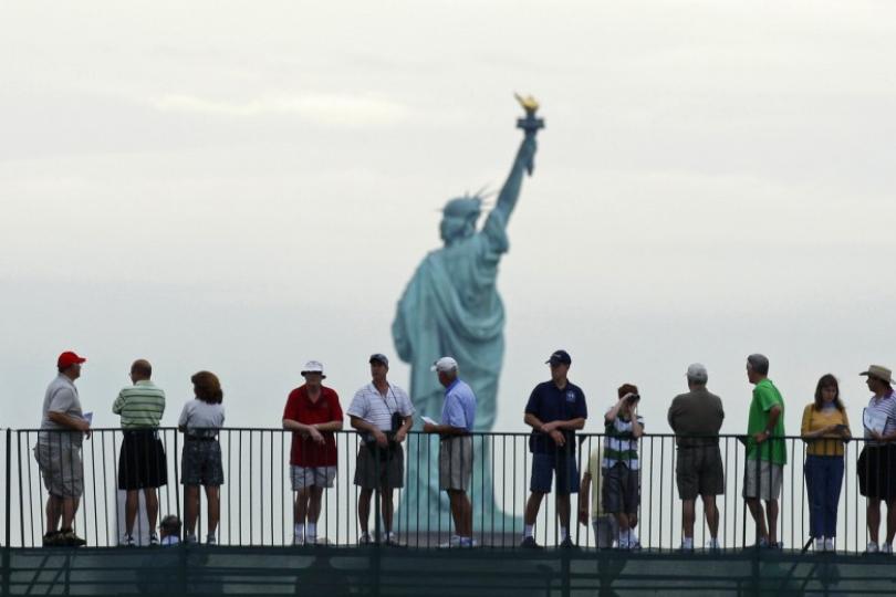 Tourists Enjoying Sightseeing Of Statue Of Liberty