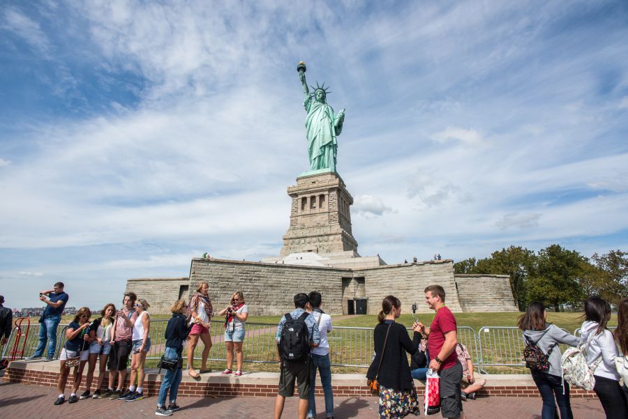 Tourists Near Statue Of Liberty Island