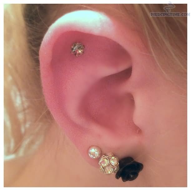 Triple Lobe And Outer Conch Piercing On Girl Right Ear