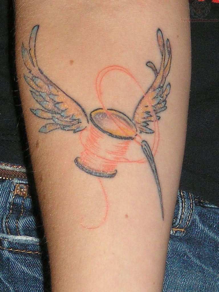 Winged Spool Quilting Tattoo On Forearm