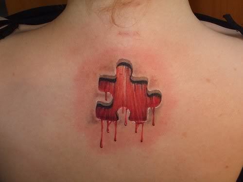 3D Red Blood Missing Puzzle Tattoo On Upper Back