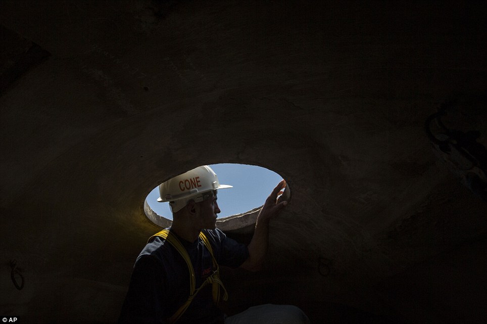 A Worker Looks Outside From Inside The Head Of Christ the Redeemer Statue