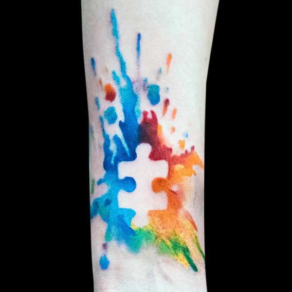 Autism Puzzle Piece Watercolor Tattoo On Wrist.