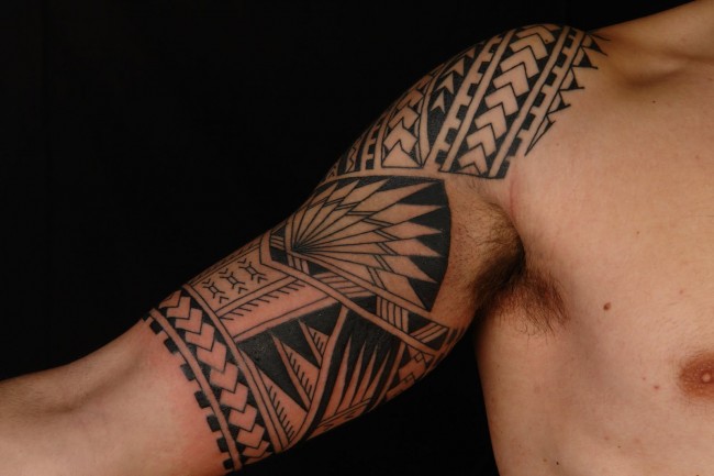 Black And Grey Maori Tattoo On  Upper Arm