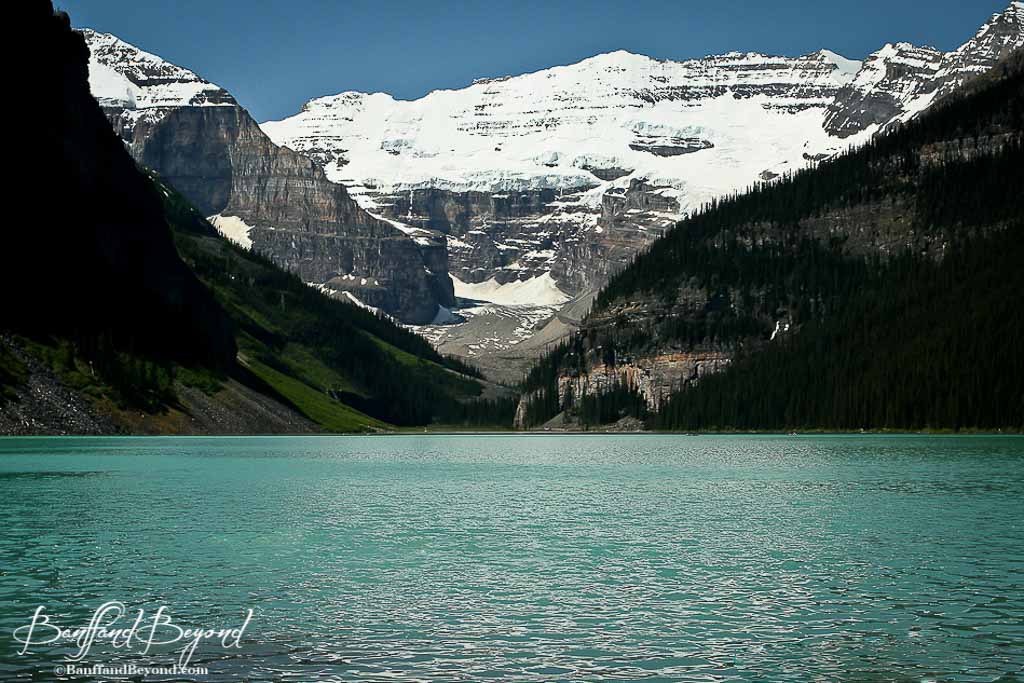 Blue Water Lake Louise And Snow Covered Mountain Picture