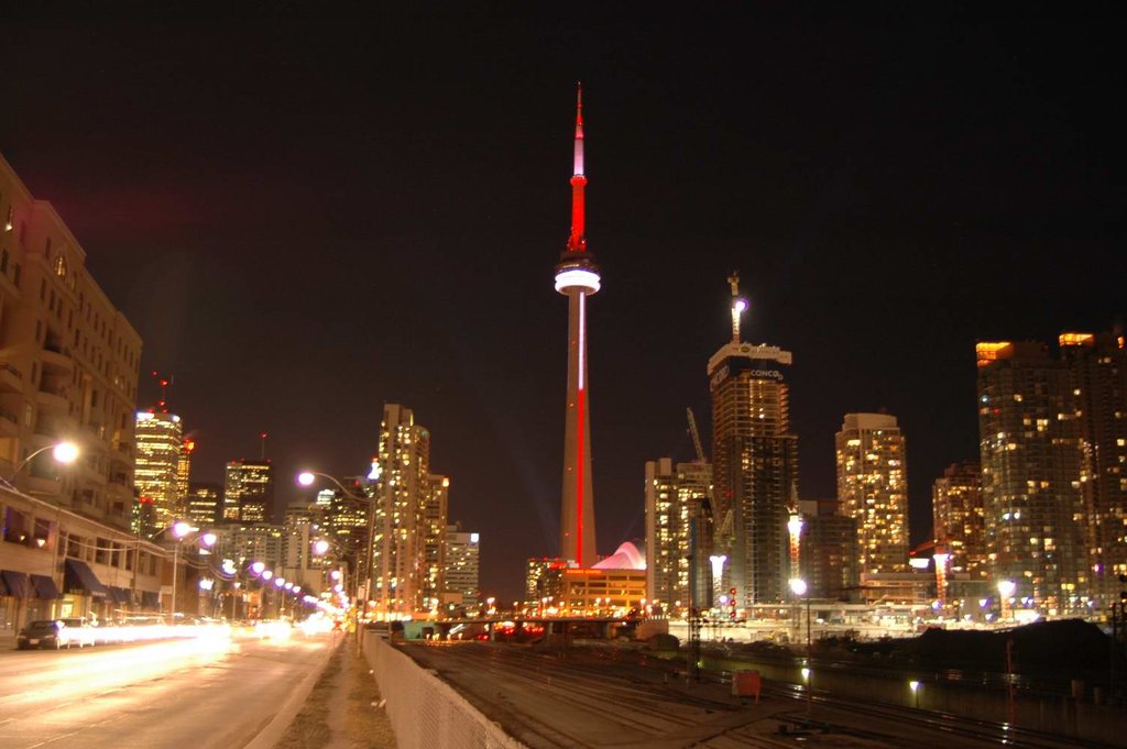 CN Tower Lit Up With Red And White Lights During Night