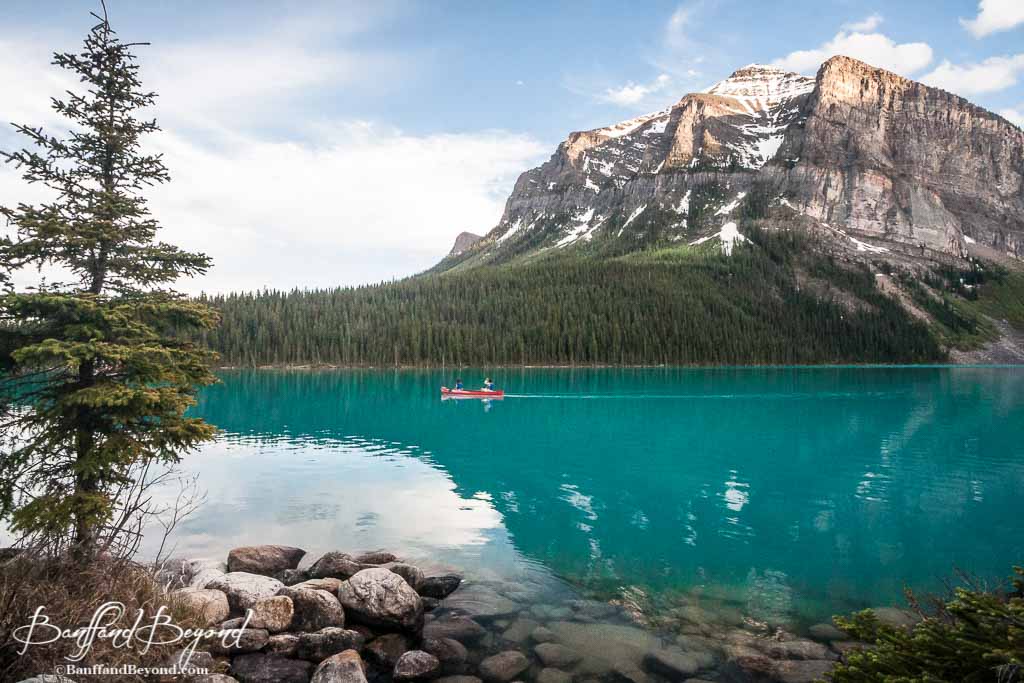 Canoe In Solitude On Turquoise Waters Of Lake Louise