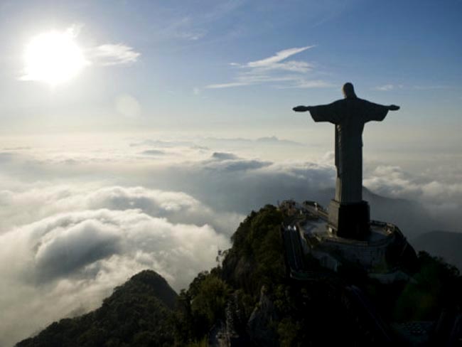 Christ The Redeemer During Sunrise Above The Clouds View Image
