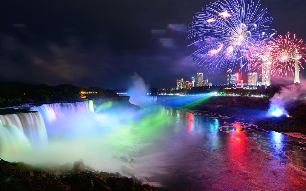 Colorful Lights And Fireworks Over The Niagara Falls At Night