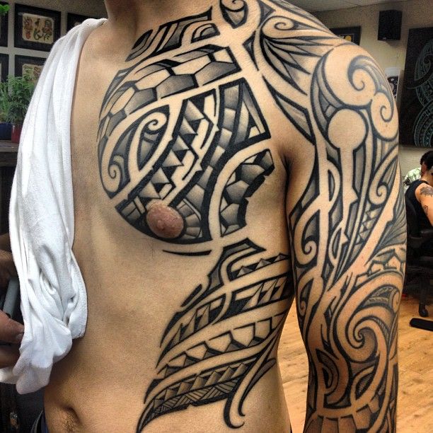 Cool Chest And Sleeve Maori Tattoo