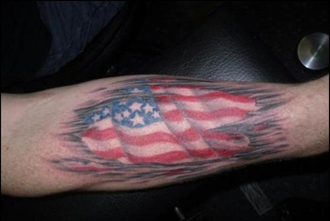 Cool Ripped Skin US Flag Patriotic Tattoo On Arm.