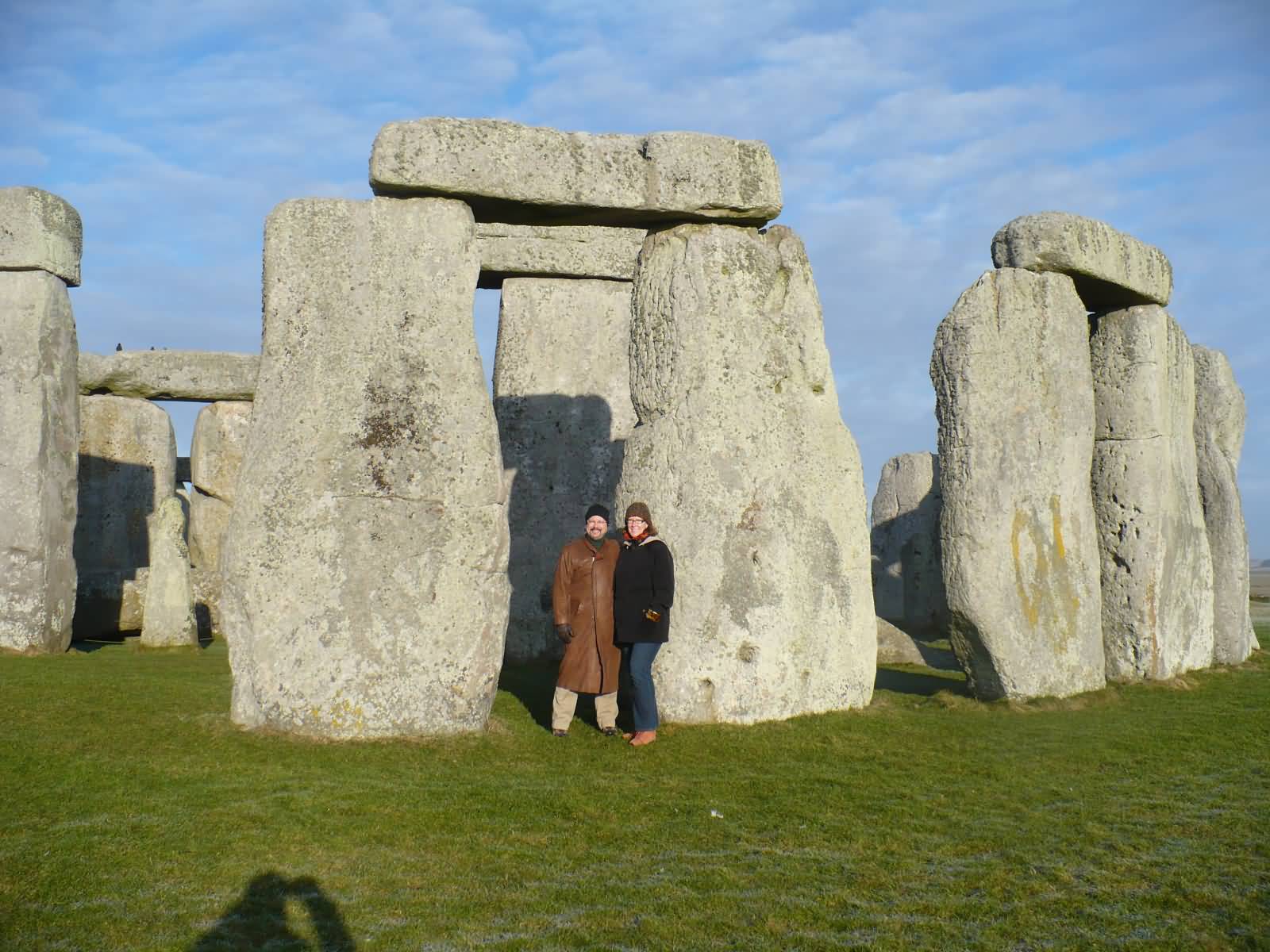 Couple Posing For Photograph With Stonehenge