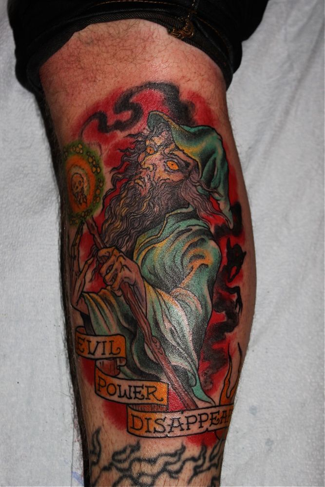 Evil Power Disappear Wizard Tattoo On Leg by Chris Nunez.