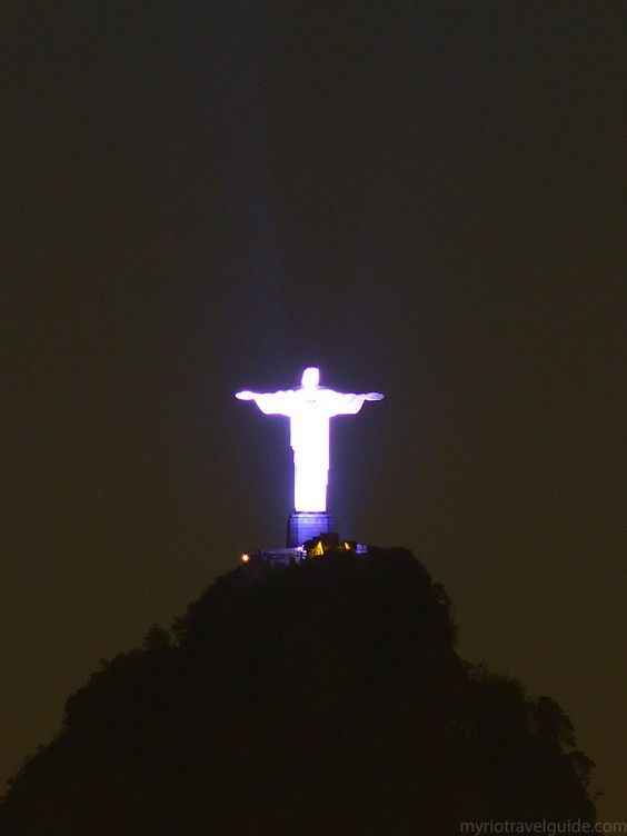 Far View Of Christ the Redeemer Statue Atop Corcovado Mountain Lit Up At Night