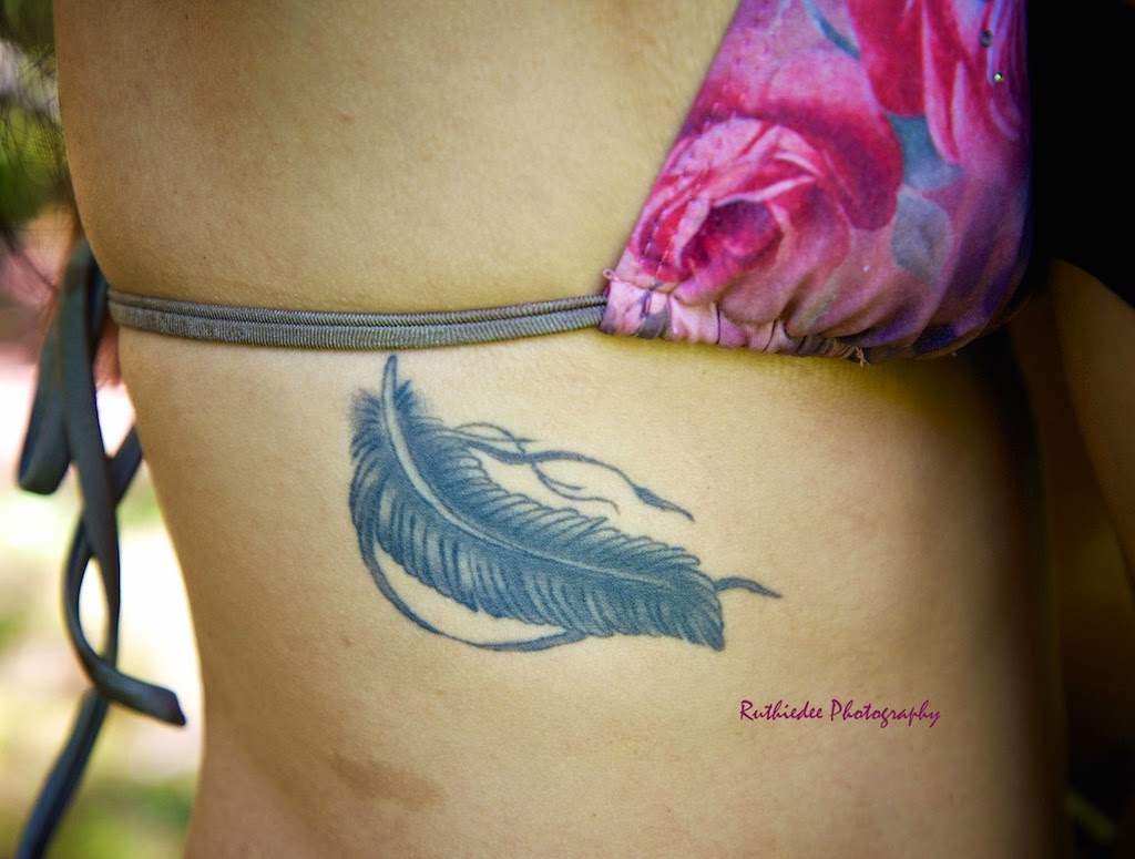 Feather Tattoo On Right Rib Cage For Girls