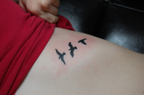 Flying Birds Silhouette Tattoo On Left Rib Cage